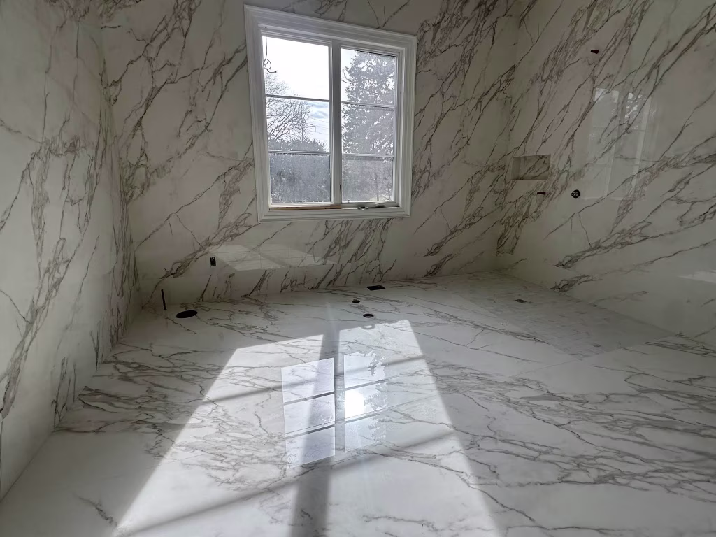luxury-marble-look-bathroom-renovation-with-window-and-tiled-walls Large-Format Porcelain & Marble Tile Installation - 2