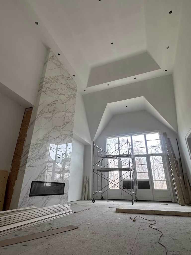 vaulted-living-room-renovation-with-marble-fireplace-and-large-windows Large-Format Porcelain & Marble Tile Installation - 3